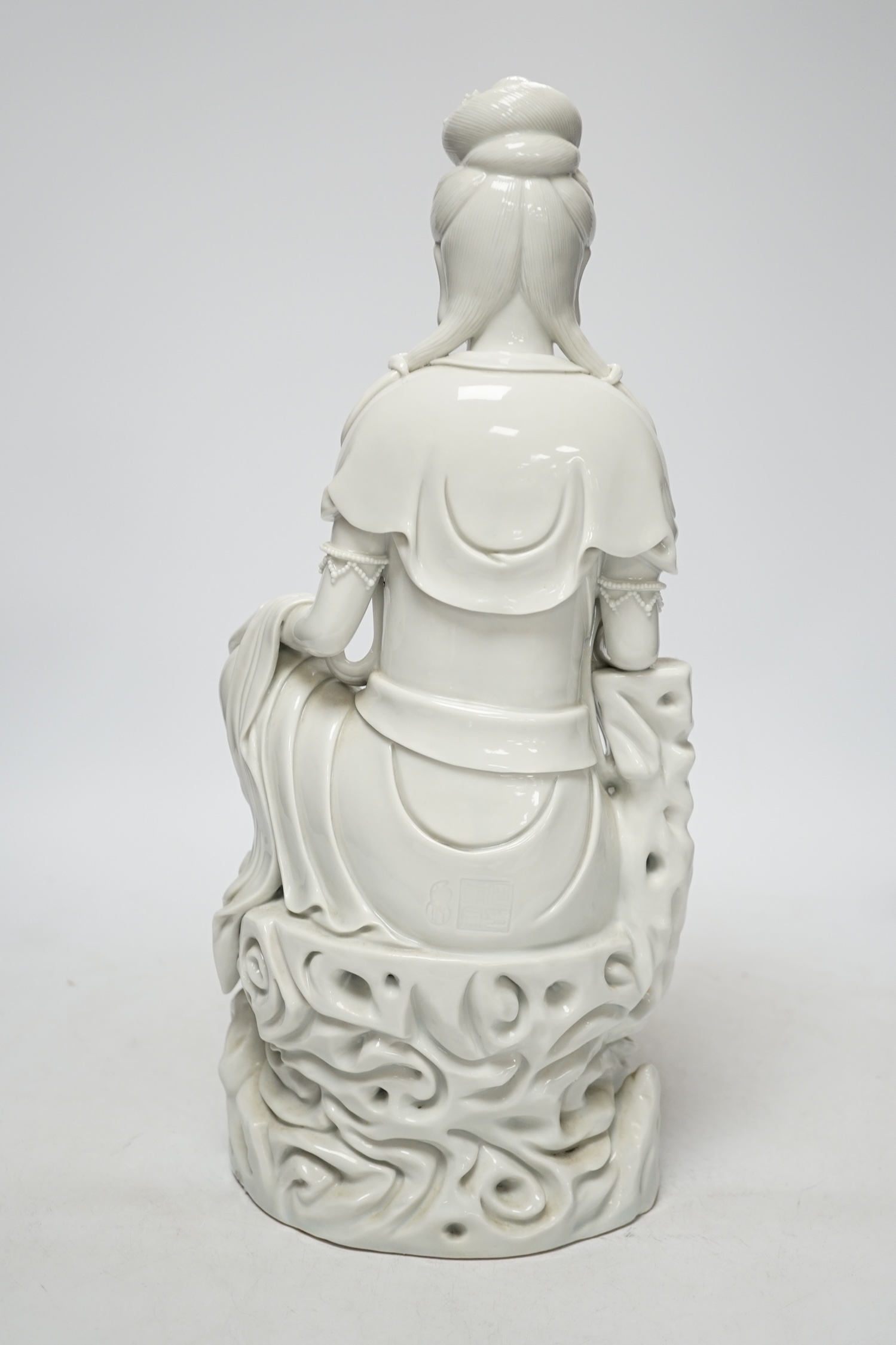 A late 19th / early 20th century Chinese blanc de Chine seated figure of Guanyin, impressed mark to back, 38cm